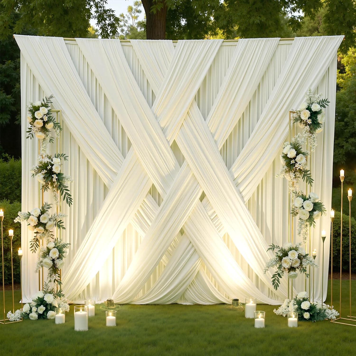 Ivory draped backdrop styled with flowers and candles